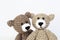 Crocheted gray and brown bears on a white background. Crocheted toy.