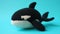 Crocheted killerwhale toy vibrant backdrop, handcrafted and adorable, Ai Generated