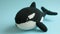 Crocheted killerwhale toy vibrant backdrop, handcrafted and adorable, Ai Generated