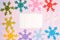 Crocheted multi-colored snowflakes. Crocheted doily. Handmade creativity. Bright christmas card on pink and purple background.