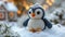 A crocheted penguin sitting in the snow, handcrafted knitted miniature toy.