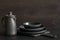 Crockery, clayware, dark utensils and stuff on dark tabletop. Kitchen still life