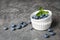 Crockery with juicy and fresh blueberries on table