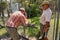 Crocodile farmer Tabone opens pen for an unidentified tourist to make a photo of a freshwater crocodile in Jonston River, Aus