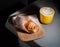 Croissant with banana and cappuccino close up, on dark background