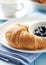 Croissant with blackberry marmalade on a plate