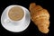 Croissant with cappuccino. Traditional sweet breakfast