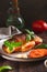 Croissant caprese sandwich baked with tomatoes and cheese on a plate vertical view