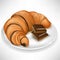 Croissant with chocolate pieces on plate