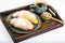 Croissant, honey and espresso in blue vintage bowl on wooden tray