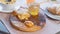 Croissant, honey jar and orange juice on wooden cutting board. Healthy breakfast