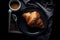 Croissant lying on a black plate, a mug with coffee, top view, dark style photography shot, ad background.