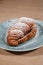 croissant with nutella and cashews on a plate