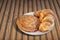 Croissant Puff Pastry Snail Rolls Sprinkled with Sesame Seeds on Bamboo Place Mat