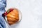 Croissant and red currant berries on plate