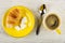 Croissant, sugar on saucer, spoon, cup with coffee on wooden table. Top view