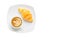 Croissant on white plate with Latte art on cappuccino coffee mug isolated over white background with clipping path. Croissant