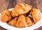 Croissants with chocolate on a white plate, breakfast