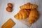 Croissants with coffee cups with flour and eggs on a white background, breakfast, brown bread, morning drinks, fantasy world:
