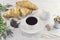 Croissants, a cup of coffee with a slice of natural cocoa liquor, milk and cane organic unrefined sugar on a light vintage provenc