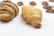 Croissants and curly cookies on white background