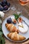 Croissants, figs and camamber cheese in a white ceramic plate