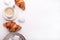 Croissants, glazed cookies and a cup of coffee on a white wooden table. Morning still life. Top view with space for text.