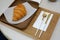 croissants and golden fork  golden Knife on wooden tray. French bakery concept.