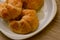 Croissants pastry in white dish on the wooden table.