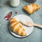 Croissants with raspberry jam, ricotta cheese and milk in bottle