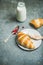 Croissants with raspberry jam, ricotta cheese and milk, copy space