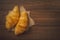 Croissants on sackcloth over wooden background. Croissant french breakfast. Top view