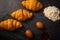 Croissants with white coffee cups with flour and eggs on a black background, breakfast, brown bread, morning drinks Concept: