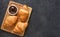 Croissants on a wooden board with chocolate paste. View from above