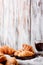 Croissants in wooden plates with coffee on a light background