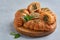 Croissants with zaatar on wooden board. Closeup