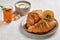 Croissants with zaatar on wooden board and cup of tea