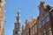 Crooked and colorful heritage buildings, located along Bloemstraat street, with Westerkerk church clocktower in the background