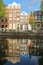 Crooked and colorful heritage buildings, overlooking Herengracht canal with perfect reflections, Amsterdam