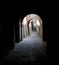 A crooked curved alley with arches, between dark and light, Tuscania, Tuscia, Lazio, Italy