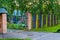 Crooked gate to the Playground. Multicolored fence and gate in the rural kindergarten