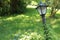 Crooked lamp post in green grass and lawns.