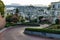 Crooked Lombard street at  dawn. San Francisco is in early morning light