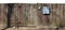 Crooked ugly wooden rural aged fence with mail box isolated on
