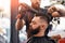 Crop barber styling hair of bearded man