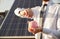 Crop businessman saving money near solar panel