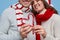 Crop couple making heart from candy canes during Christmas