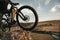 Crop cyclist with bike on cliff