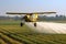 Crop Duster plane spraying crops.