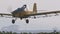 Crop duster spraying chemicals over a cotton field - slow motion